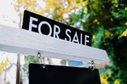 Close-up of for sale rider on real estate sign