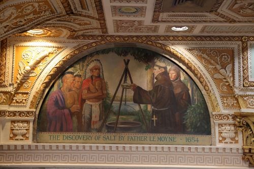 Palladian Hall features 10 historic scenes painted by William Tefft Schwarz, showing key moments in Onondaga County history. This arch shows the 1654 discovery of Syracuse's salt springs by Father Le Moyne. 

Palladian Hall is part of The Treasury, a renovated rebrand in the space formerly known as the Onondaga County Savings Bank at 101 S. Salina St., Syracuse. (Katrina Tulloch)
