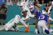 Miami Dolphins safety DeShon Elliott (21) intercepts a pass in the end zone intended for Buffalo Bills wide receiver Gabe Davis (13) during the first half of an NFL football game, Sunday, Jan. 7, 2024, in Miami Gardens, Fla. (AP Photo/Lynne Sladky)