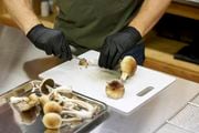 Gared Hansen cuts psilocybin mushrooms in his Uptown Fungus lab to prepare for distribution in Springfield, Oregon, Monday, Aug. 14, 2023. (Craig Mitchelldyer | AP Photo)