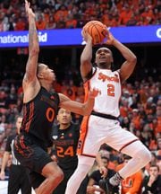 Syracuse Orange guard JJ Starling (2) with a jumper over Miami (Fl) Hurricanes guard Matthew Cleveland (0). The Syracuse men’s basketball team host the Miami Hurricanes at the JMA Wireless Dome Jan 20, 2024.   (Dennis Nett | dnett@syracuse.com)