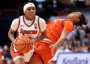 Syracuse Orange guard Dyaisha Fair (2) draws the blocking foul on Clemson Tigers guard Dayshanette Harris (1). The Syracuse Orange Women’s basketball team takes on the Clemson Tigers, Jan. 14, 2024 at the JMA Wireless Dome in Syracuse N.Y.  ( Dennis Nett | dnett@syracuse,com )