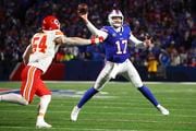Buffalo Bills quarterback Josh Allen (17) throws a touchdown pass under pressure from Kansas City Chiefs linebacker Leo Chenal (54) during the third quarter of an NFL AFC division playoff football game, Sunday, Jan. 21, 2024, in Orchard Park, N.Y. (AP Photo/Jeffrey T. Barnes)