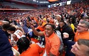 After Syracuse guard Quadir Copeland's game-winning shot, the crowd rushed the floor. Some of the revelers included Syracuse football players LeQuint Allen and Elijah Clark. (Dennis Nett | dnett@syracuse.com)