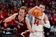 Colgate's Ryan Moffatt fouls Wisconsin's Brad Davison during the second half of a first-round NCAA college basketball tournament game Friday, March 18, 2022, in Milwaukee. (AP Photo/Morry Gash)