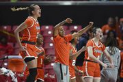 The Syracuse bench cheers during an NCAA basketball game on Sunday, Nov. 19, 2023, in College Park, Md. (AP Photo/Gail Burton)