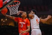 Syracuse guard Judah Mintz goes in for a basket as Miami's Harlond Beverly defends in a game last season. Miami and Syracuse meet for the first time this year on Saturday at the JMA Wireless Dome. N. Scott Trimble | strimble@syracuse.com